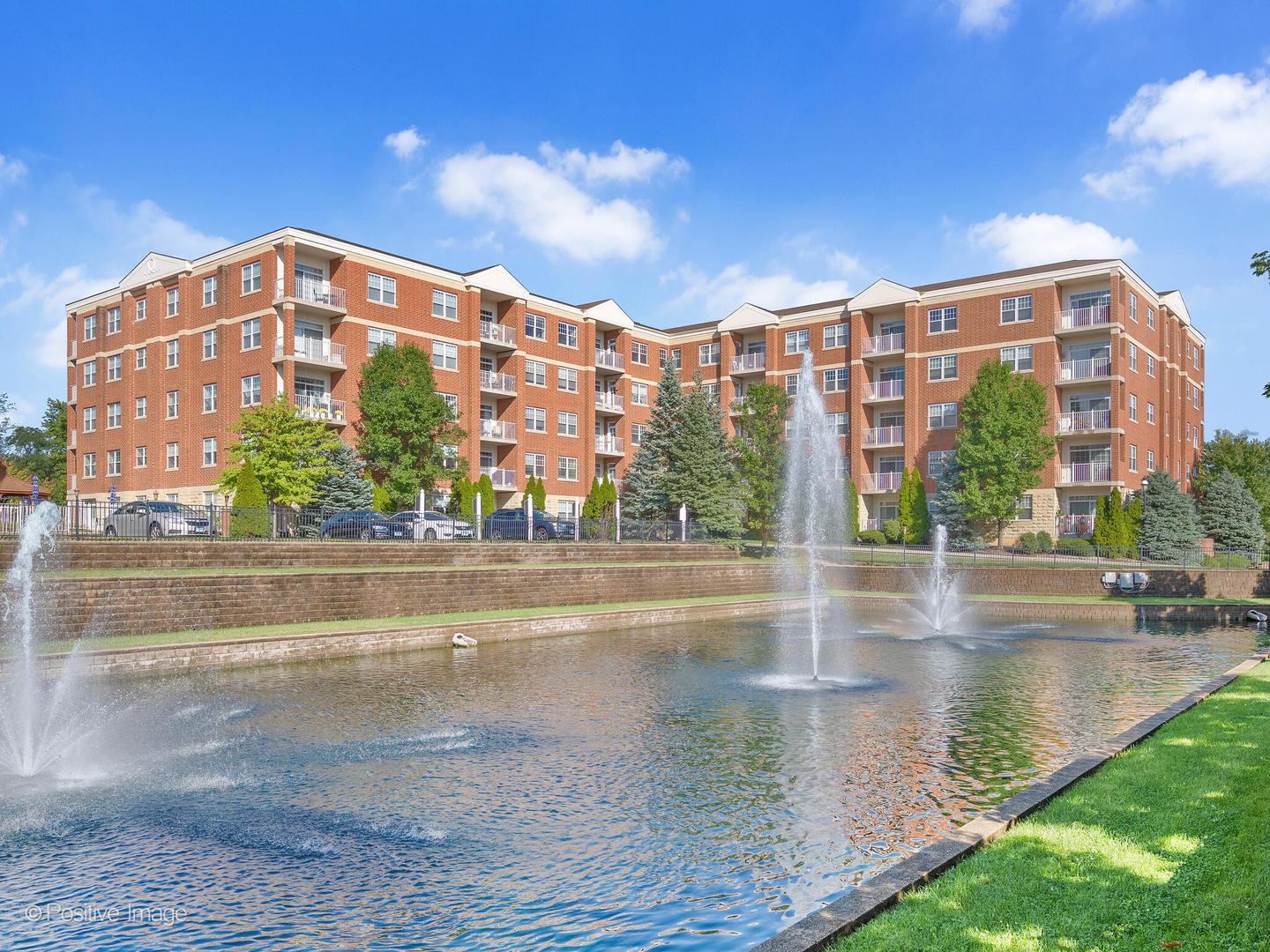 a view of building with lake view and tall windows