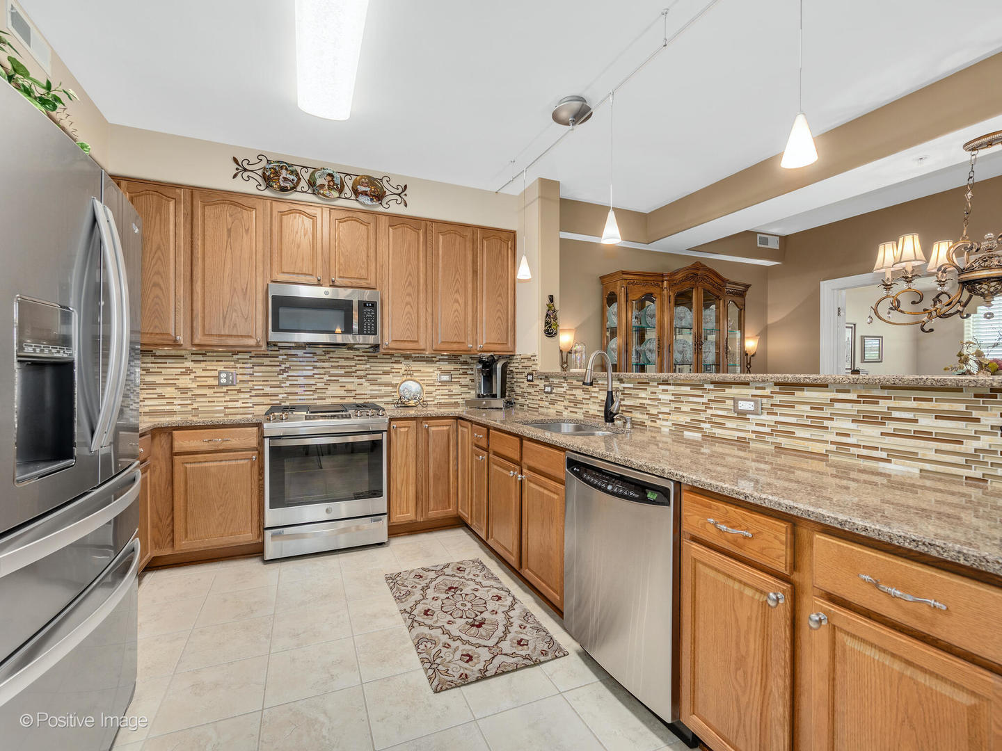 1 Itasca Place, Unit 306 Addison, IL 60143 - Photo 8 of 24 a large kitchen with granite countertop a sink cabinets stainless steel appliances and a counter space