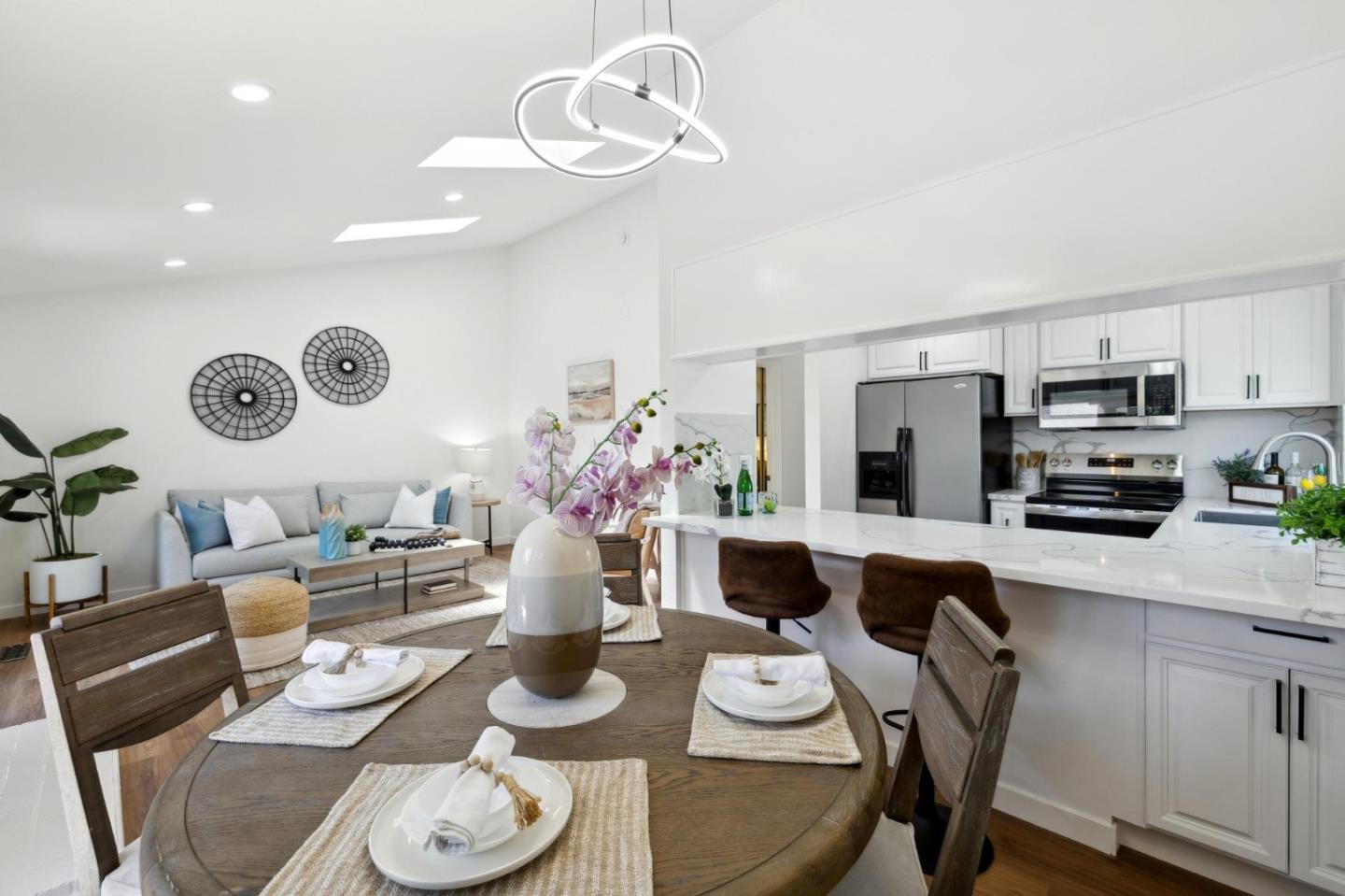 10892 Northfield Square Cupertino, CA 95014 - Photo 16 of 78 a kitchen with stainless steel appliances a dining table and chairs