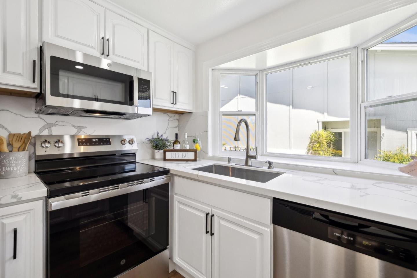 10892 Northfield Square Cupertino, CA 95014 - Photo 17 of 78 a kitchen with stainless steel appliances a stove microwave and sink