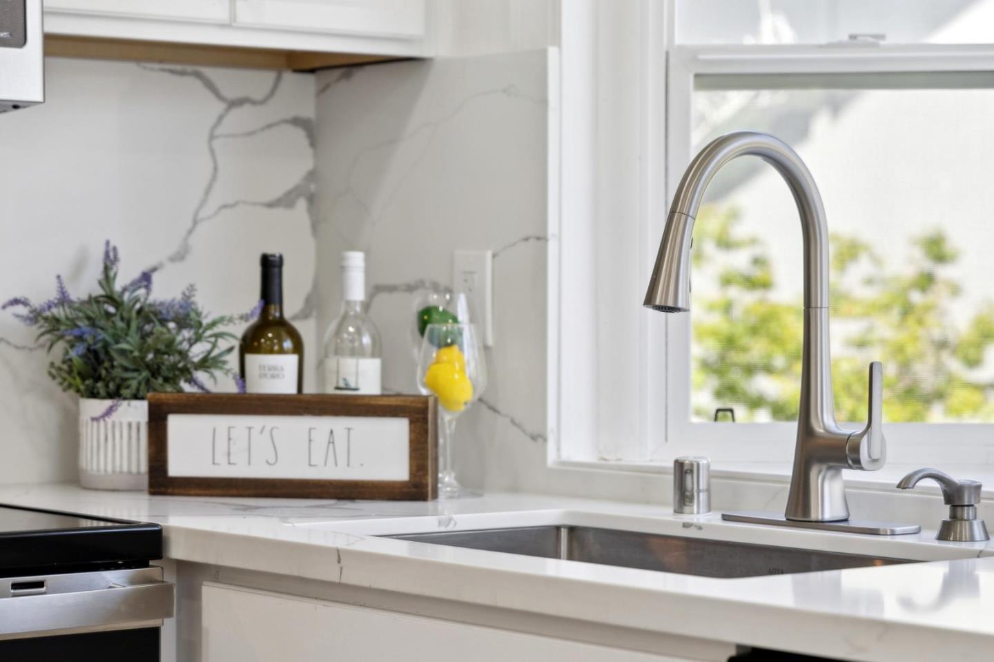 10892 Northfield Square Cupertino, CA 95014 - Photo 19 of 78 a kitchen with a sink and a potted plant on the counter