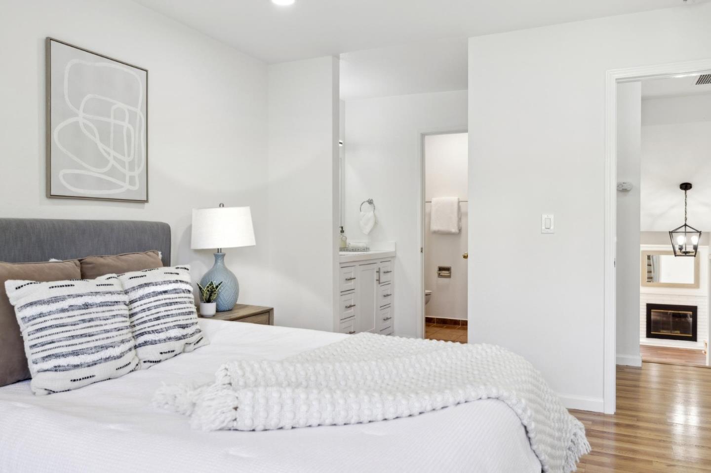 10892 Northfield Square Cupertino, CA 95014 - Photo 26 of 78 a bedroom with a bed and a painting on the wall