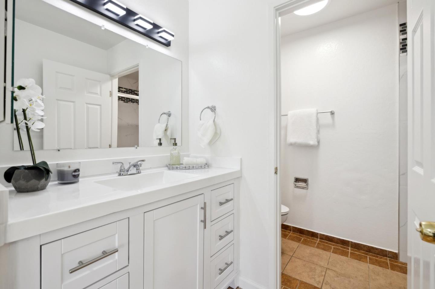 10892 Northfield Square Cupertino, CA 95014 - Photo 27 of 78 a bathroom with a double vanity sink and a mirror