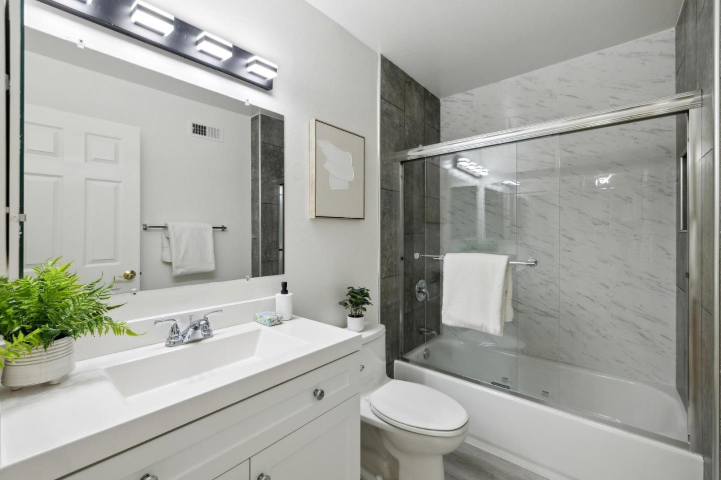 10892 Northfield Square Cupertino, CA 95014 - Photo 30 of 78 a bathroom with a sink a toilet a mirror and shower