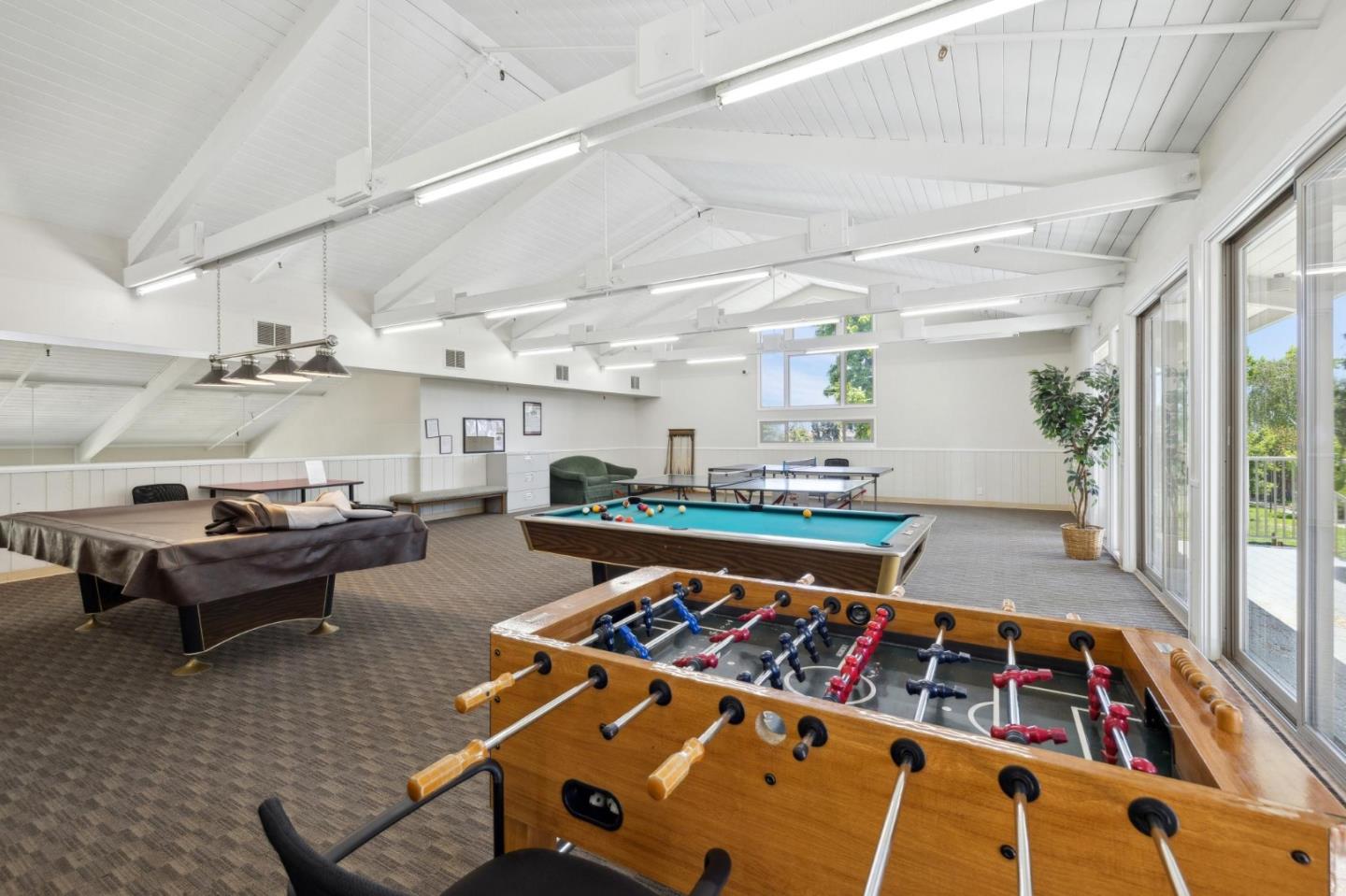 10892 Northfield Square Cupertino, CA 95014 - Photo 56 of 78 a living room with furniture a rug kitchen view and a large window