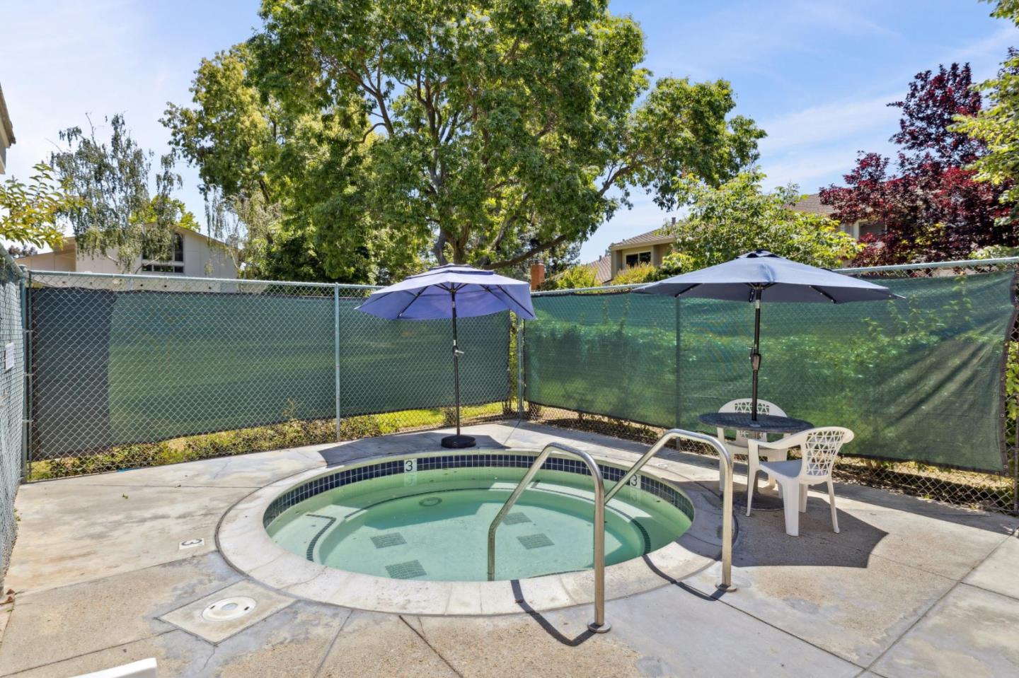 10892 Northfield Square Cupertino, CA 95014 - Photo 73 of 78 a patio with a table and chairs under an umbrella