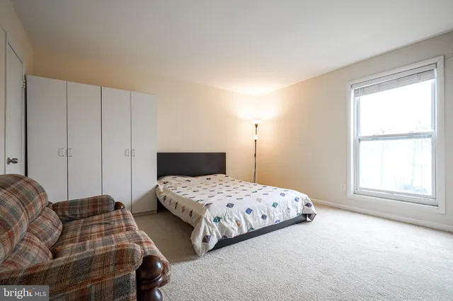 a bedroom with two beds and a window