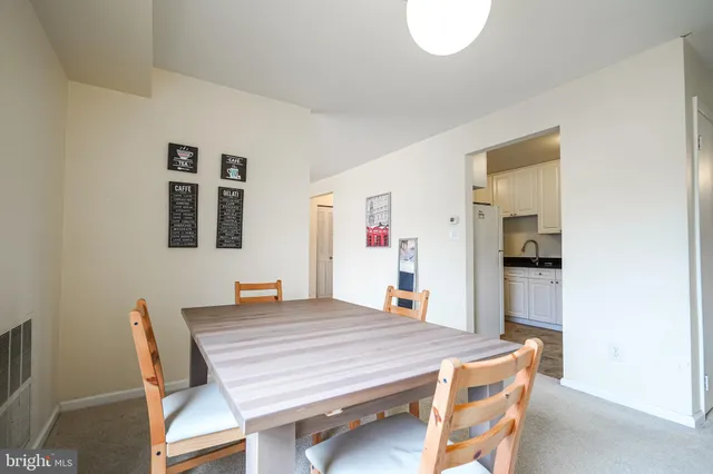 a dining room with a table and chairs