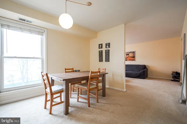 a view of a dining room with furniture and window