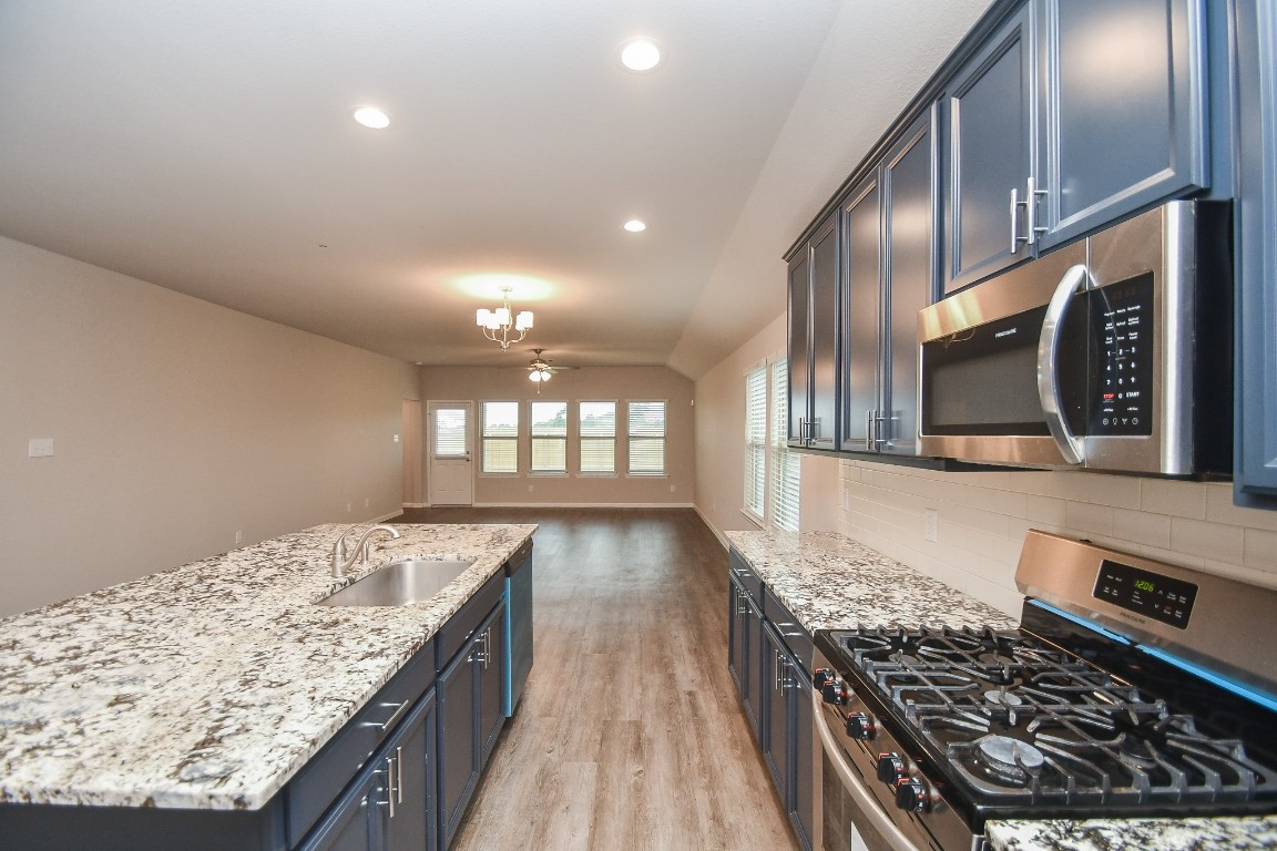 17811 Chartertree Lane Tomball, TX 77377 - Photo 11 of 32 a kitchen with a stove and a wooden floor
