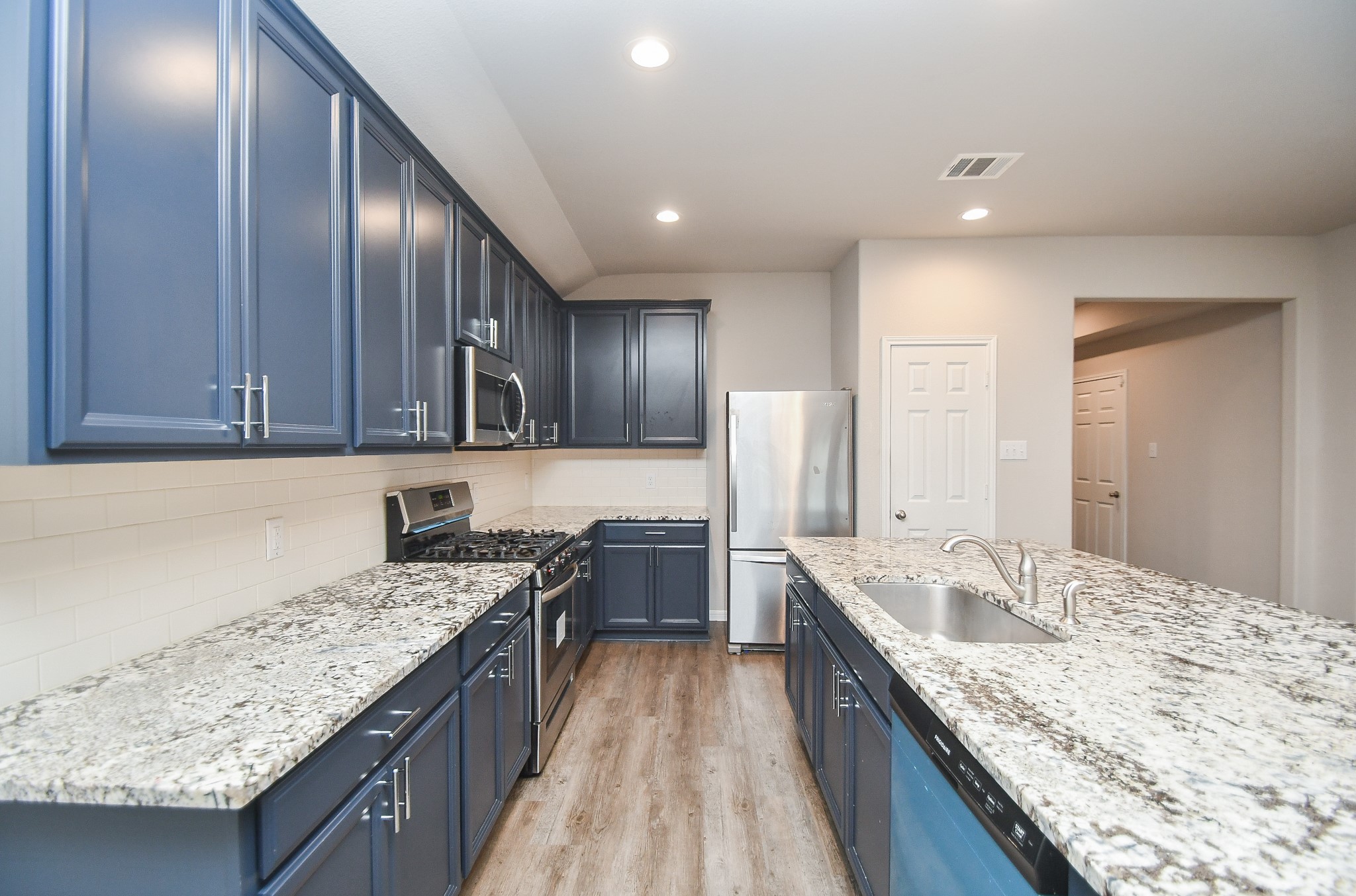 17811 Chartertree Lane Tomball, TX 77377 - Photo 12 of 32 a kitchen with granite countertop counter top space a sink stainless steel appliances and cabinets
