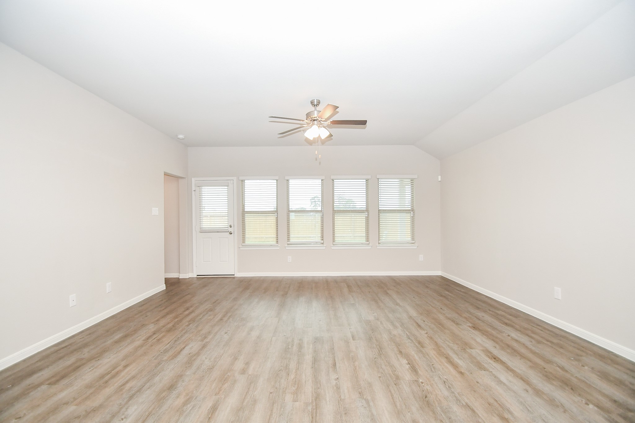 17811 Chartertree Lane Tomball, TX 77377 - Photo 14 of 32 an empty room with wooden floor and windows