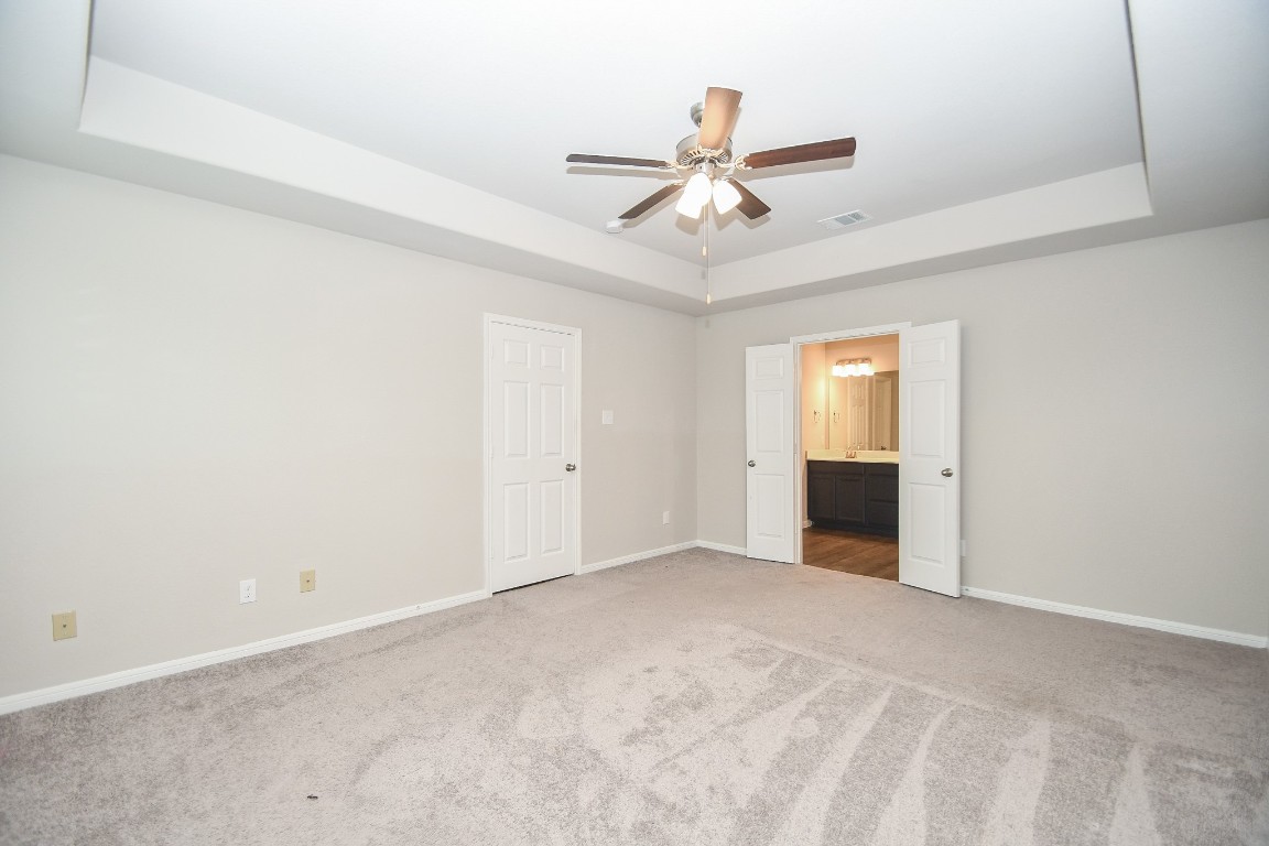 17811 Chartertree Lane Tomball, TX 77377 - Photo 17 of 32 a view of an empty room with a ceiling fan