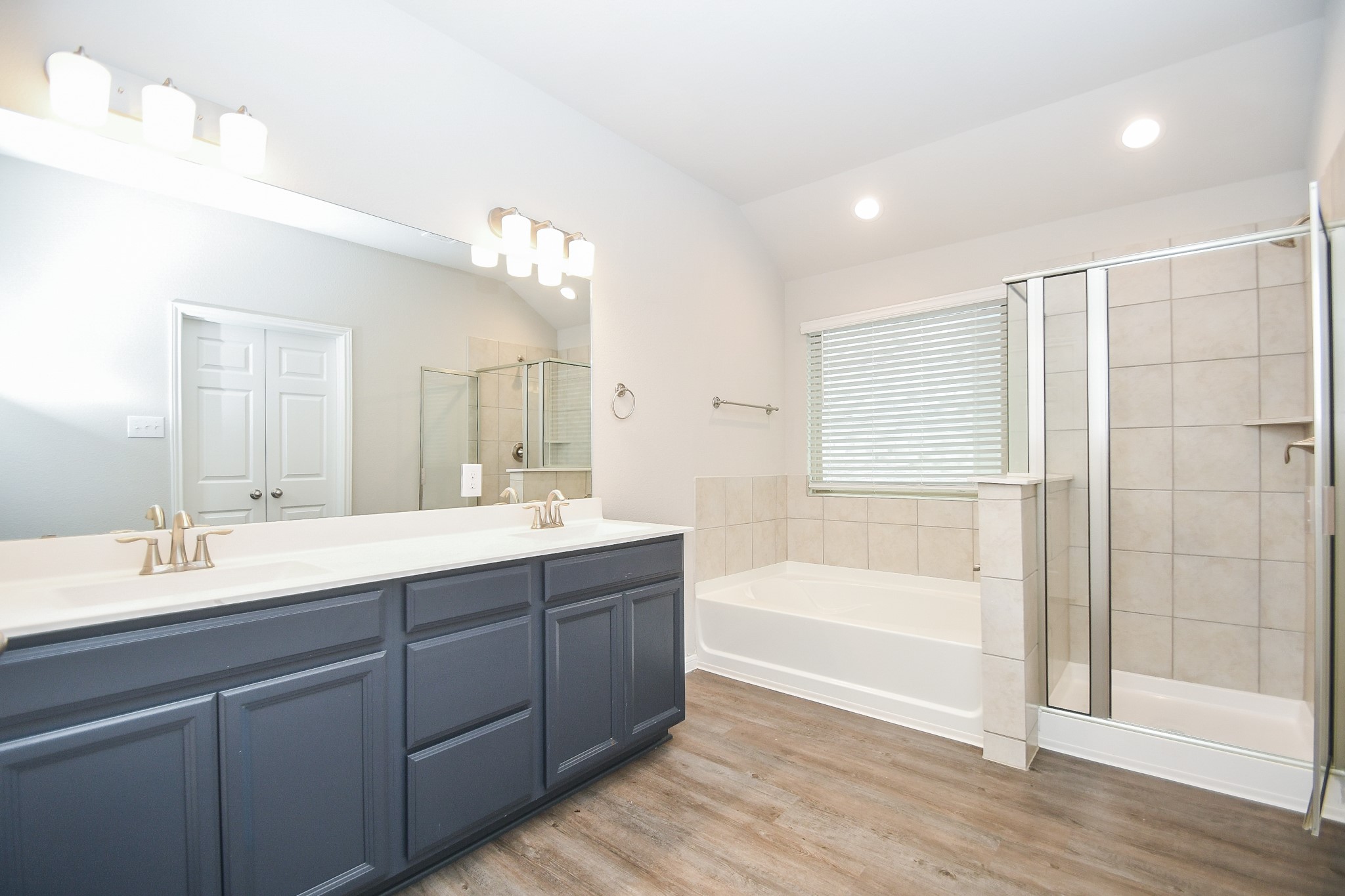 17811 Chartertree Lane Tomball, TX 77377 - Photo 19 of 32 a bathroom with a tub sink double vanity and a mirror