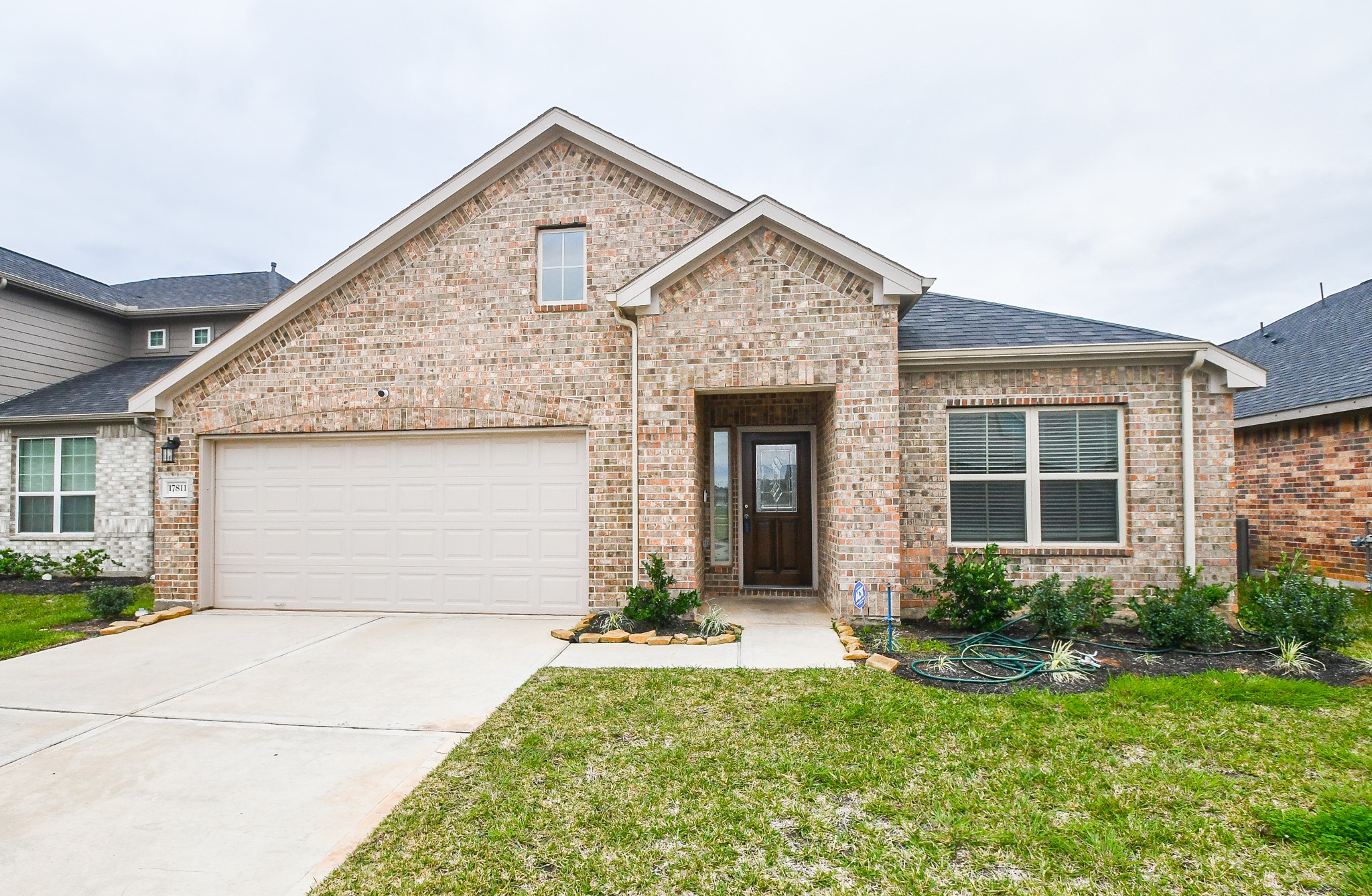 17811 Chartertree Lane Tomball, TX 77377 - Photo 2 of 32 a front view of a house with a yard and garage