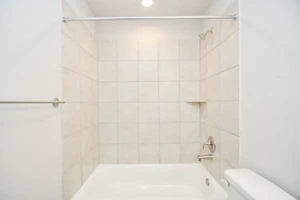 a bathroom with a bathtub and shower