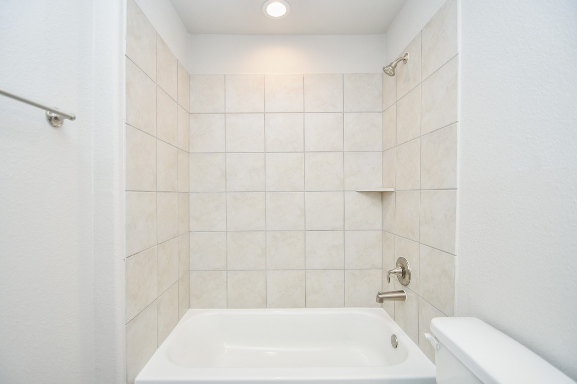 17811 Chartertree Lane Tomball, TX 77377 - Photo 29 of 32 a bath tub sitting next to a white sink and vanity