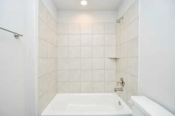 a bath tub sitting next to a white sink and vanity