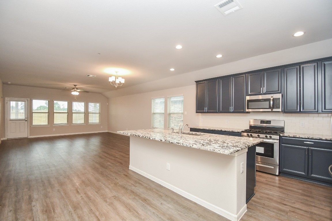 17811 Chartertree Lane Tomball, TX 77377 - Photo 5 of 32 a large kitchen with stainless steel appliances granite countertop a stove a sink and a refrigerator
