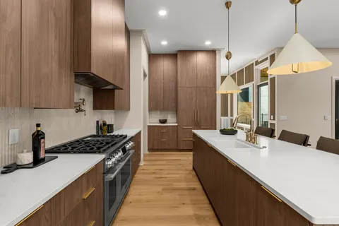 a kitchen with stainless steel appliances a sink stove and refrigerator