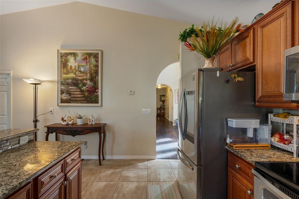 10421 Templewood Court Spring Hill, FL 34608 - Photo 15 of 63 a kitchen with stainless steel appliances granite countertop a sink stove and refrigerator