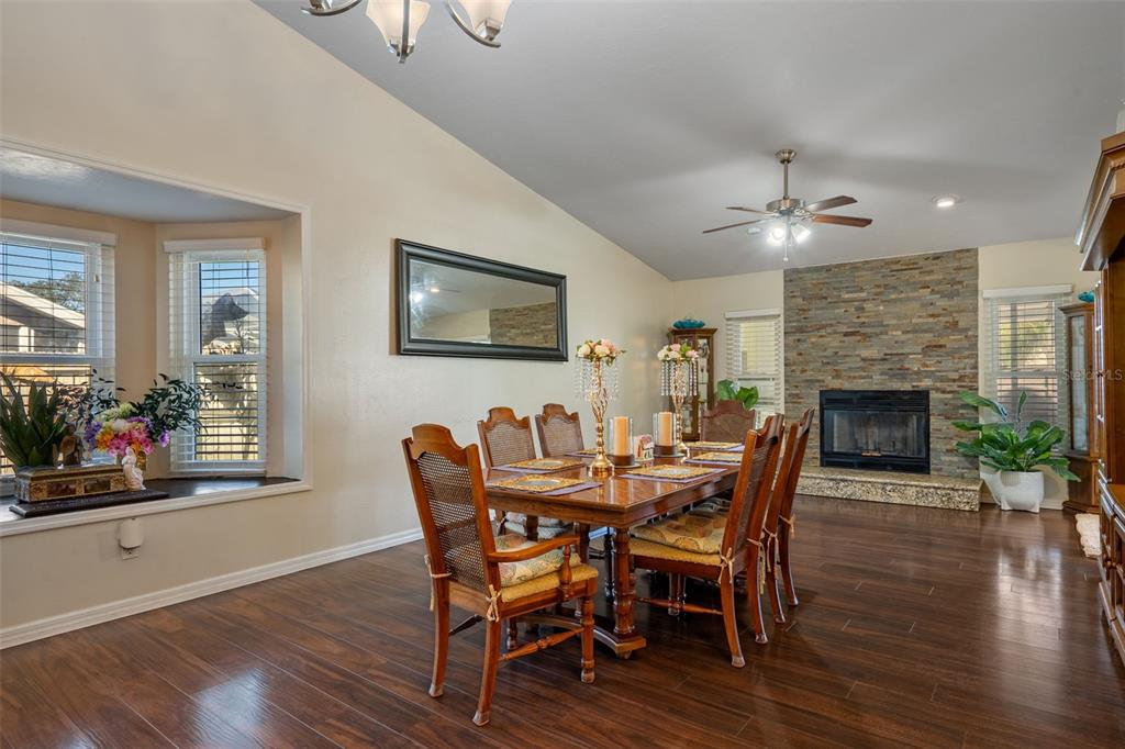10421 Templewood Court Spring Hill, FL 34608 - Photo 16 of 63 a view of a dining room with furniture window and wooden floor