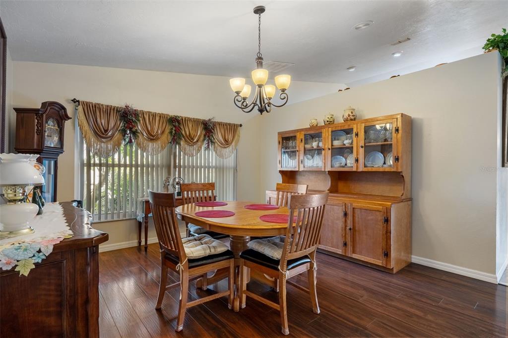 10421 Templewood Court Spring Hill, FL 34608 - Photo 21 of 63 a view of a dining room with furniture wooden floor and chandelier