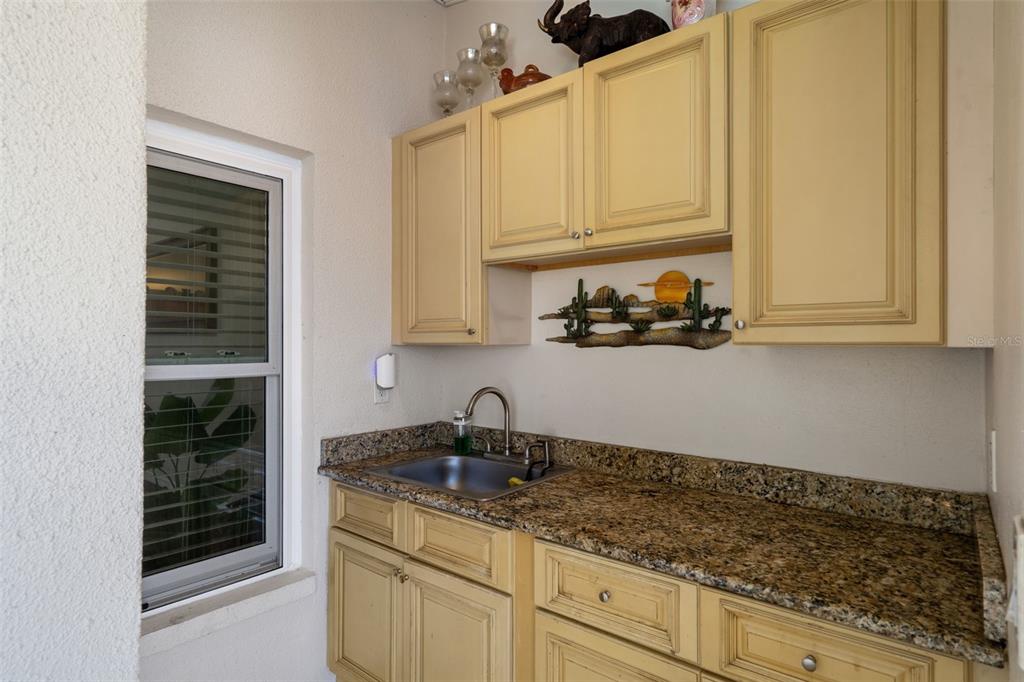 10421 Templewood Court Spring Hill, FL 34608 - Photo 47 of 63 a kitchen with stainless steel appliances granite countertop a sink and cabinets with wooden floor
