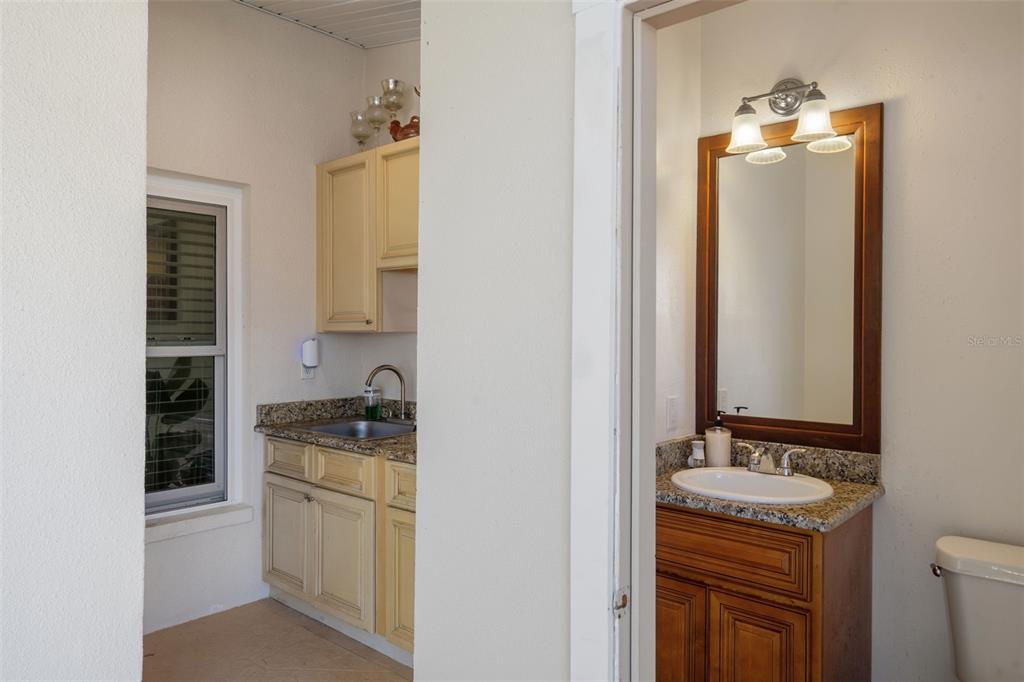 10421 Templewood Court Spring Hill, FL 34608 - Photo 48 of 63 a bathroom with a granite countertop sink and a mirror