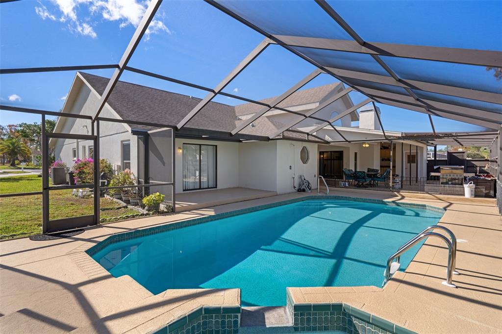 10421 Templewood Court Spring Hill, FL 34608 - Photo 52 of 63 a view of a backyard with table and chairs under an umbrella