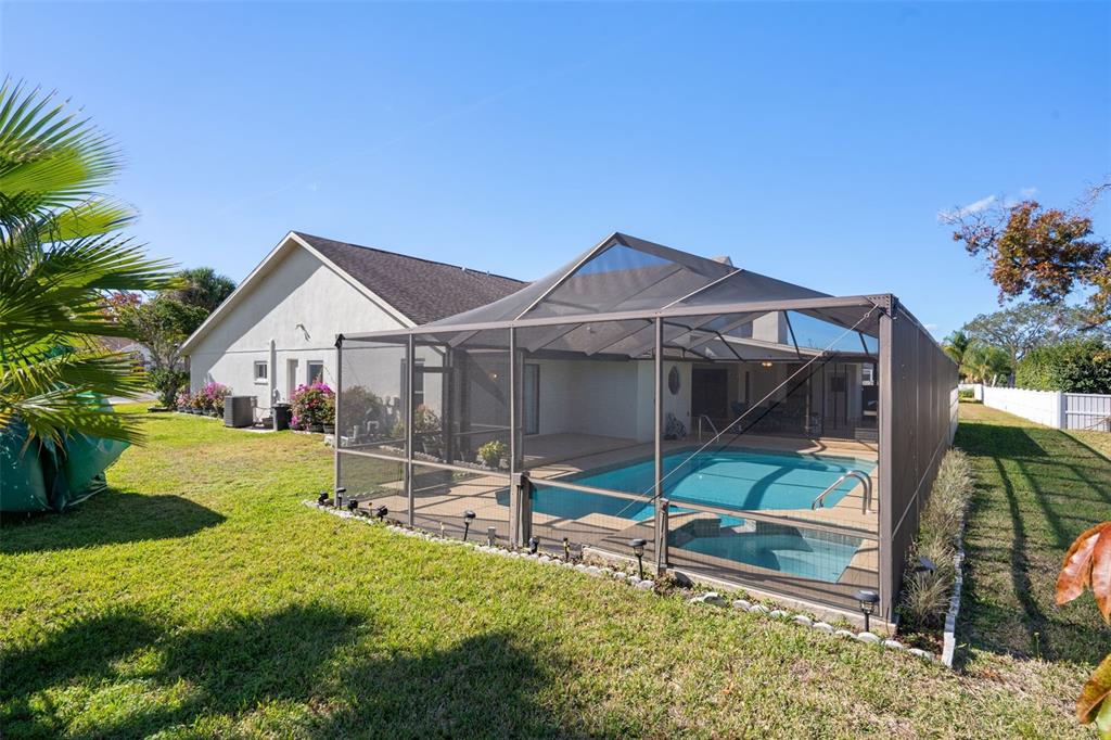 10421 Templewood Court Spring Hill, FL 34608 - Photo 55 of 63 a view of a house with a yard and a porch