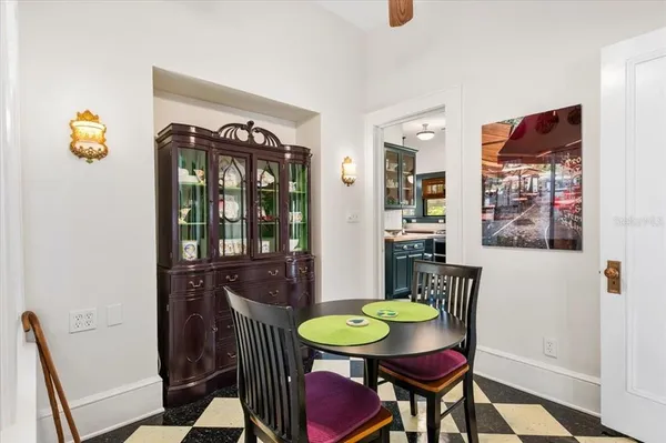 an empty room with wooden floor front door and windows