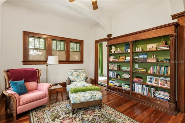a living room with patio furniture and a floor to ceiling window