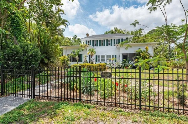 a view of a dining room with furniture a chandelier and wooden floor