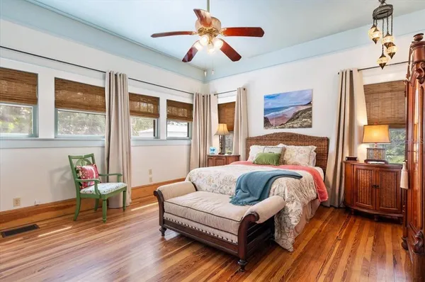 a living room with a bed and a flat screen tv
