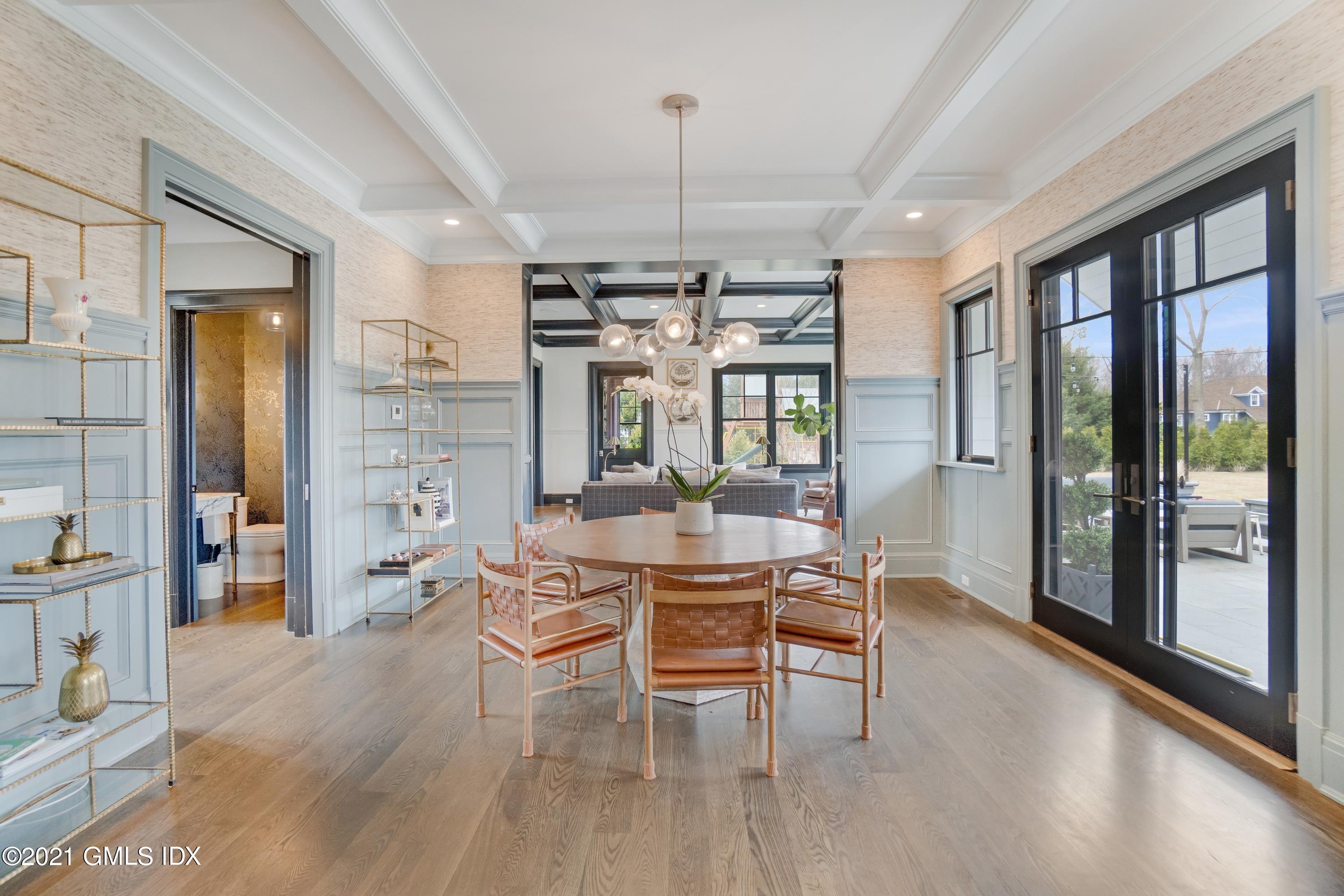 7 Turner Drive Greenwich, CT 06831 - Photo 15 of 34 a dining room with furniture a chandelier and wooden floor