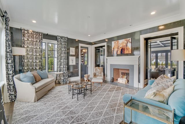 a living room with furniture large window and a fireplace