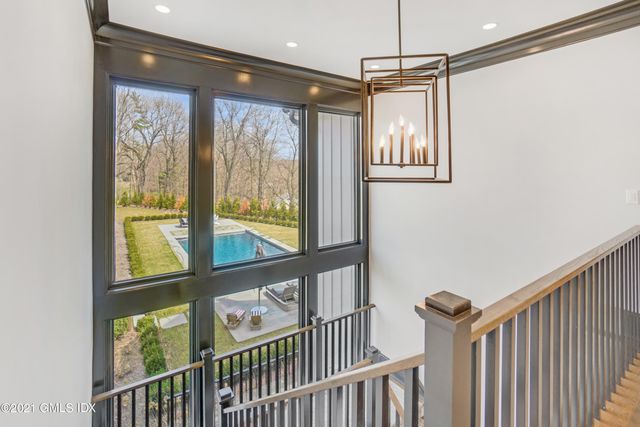 a view of a room with wooden floor and windows