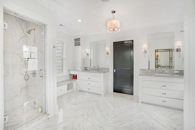 a bathroom with a shower sink and mirror