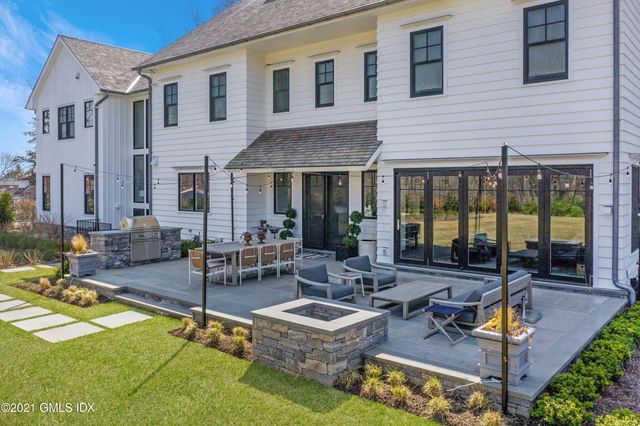a view of a house with backyard porch and sitting area