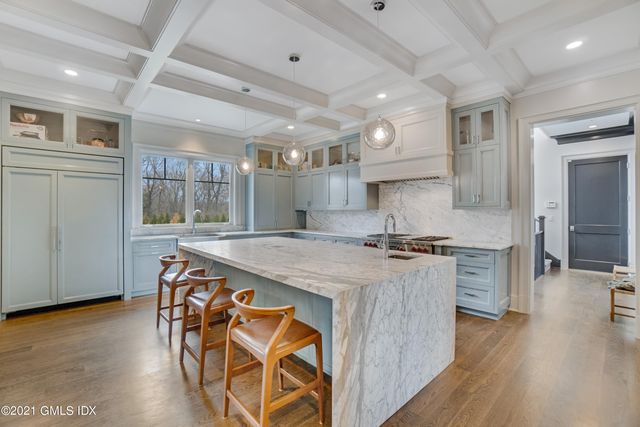 a kitchen with stainless steel appliances granite countertop a stove and a refrigerator