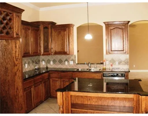 a kitchen with stainless steel appliances granite countertop a sink and cabinets