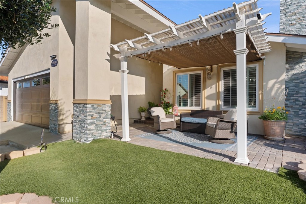 a view of a patio with couches table and chairs and potted plants