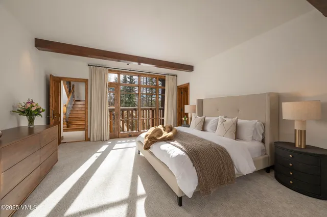 a bedroom with furniture and a large window