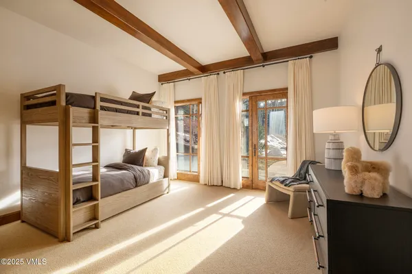 a bedroom with furniture and a large window