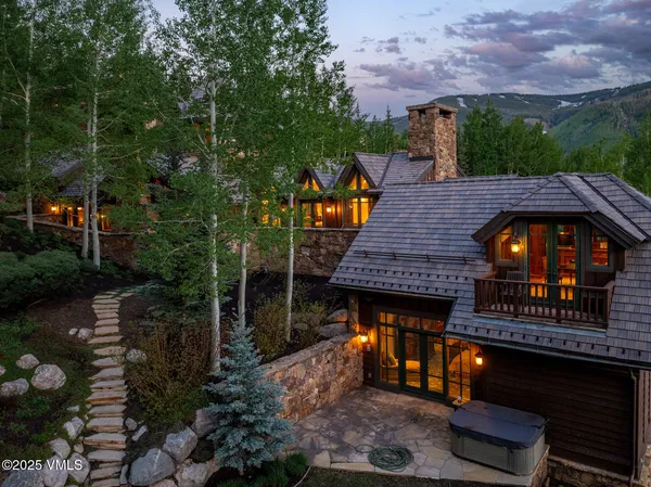 a view of a wooden deck and a patio with fire pit