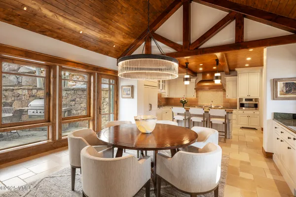 a dining room with furniture a chandelier and a rug