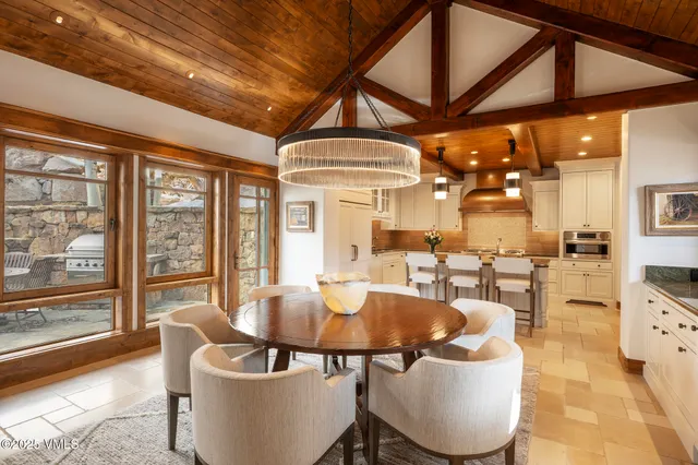 a dining room with furniture a chandelier and a rug