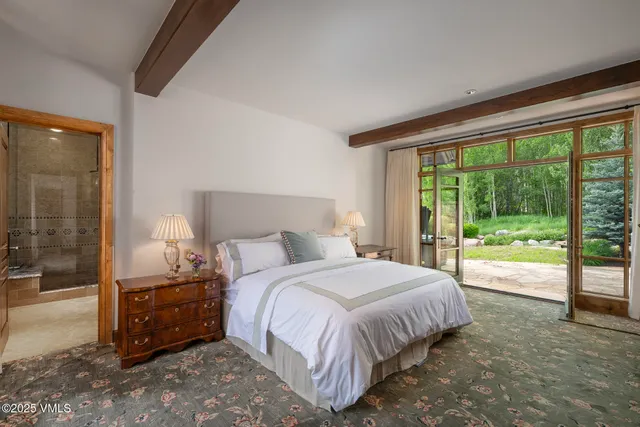 a bedroom with a bed and a large window