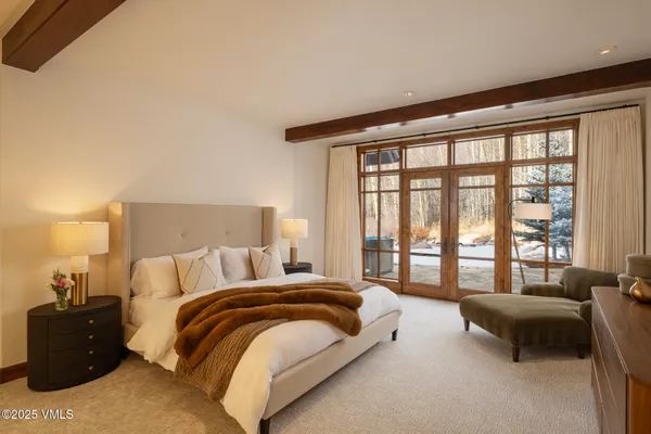 a spacious bedroom with a bed and a couch next to a window